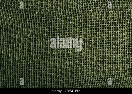 Texture photo of a green net scarf. Stock Photo