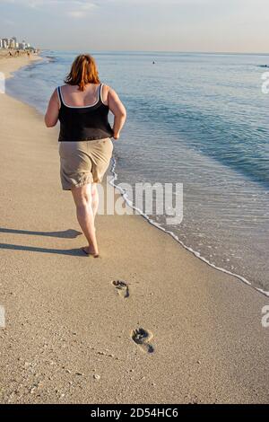 Miami Beach Florida,Atlantic Ocean shore,overweight obese fat heavy Hispanic adult woman female women,jogging jogging runs running surf exercise exerc Stock Photo