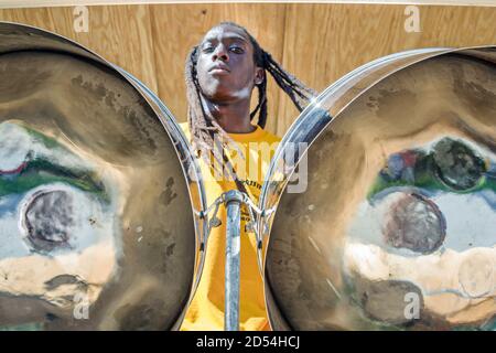 Miami Florida,Homestead Miami Carnival,Caribbean Mardi Gras masqueraders festival,Black African teen teenage teenager boy male steel drums playing pla Stock Photo