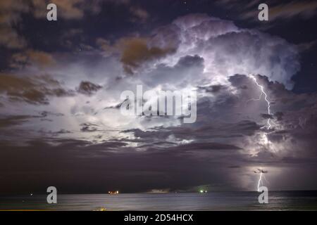 Miami Beach Florida,rainstorm thunderstorm storm,clouds clouds sky weather over Atlantic Ocean,lightning streak night