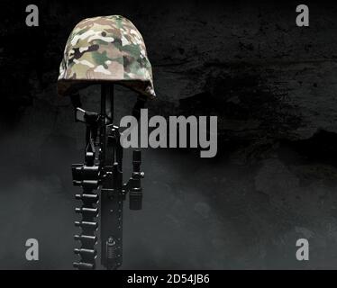 Photo of a camouflaged soldier armor helmet with rifle on dark background with fog. Stock Photo