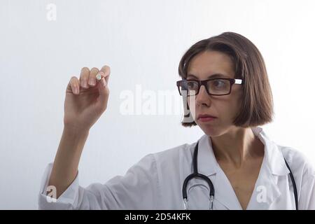 Female medical student with chalk in hand on white background Stock Photo