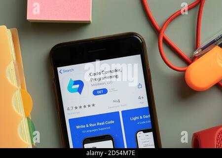 New York, USA - 28 September 2020: Code Compiler Programming mobile app logo on phone screen close up, Illustrative Editorial Stock Photo