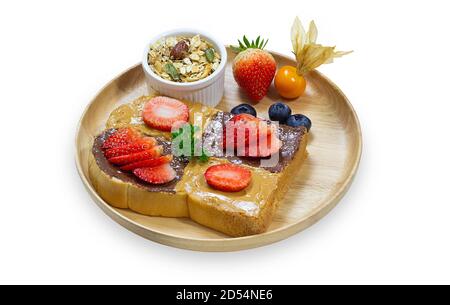 French toast sticks or honey toast stack on wooden plate with fresh fruit and vanilla ice cream on white isolated background with clipping path. Delic Stock Photo