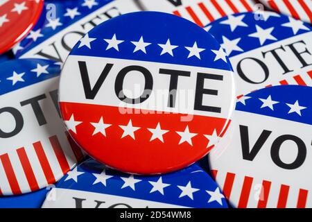 A group of red, white and blue VOTE button on a blue background Stock Photo