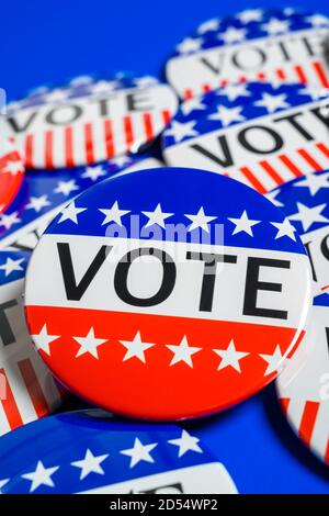 A group of red, white and blue VOTE button on a blue background Stock Photo