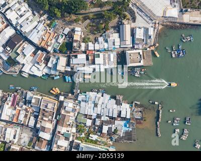 Aerial View of a boat leaving Tai O, a traditional fishing village on Lantau Island, Hong Kong Stock Photo