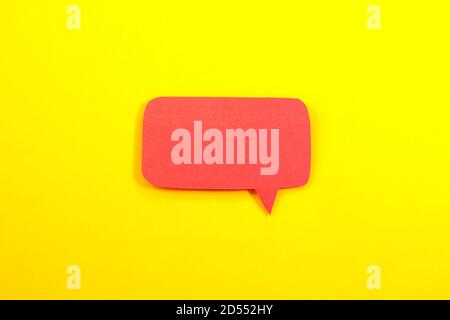 Red speech bubble on yellow background Stock Photo
