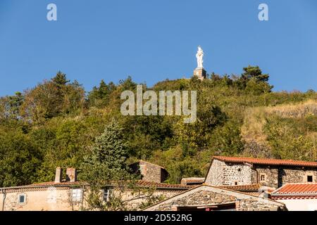 Usson, France. The Vierge Monumentale (Monumental Virgin), a large statue of the Virgin Mary overlooking the village of Usson Stock Photo