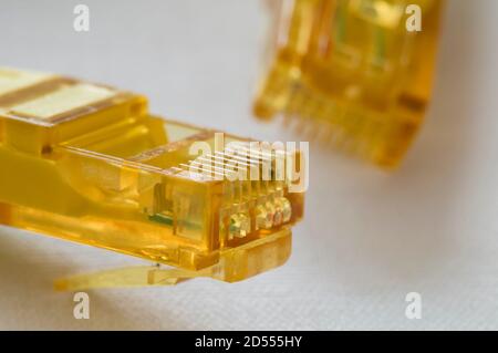 Yellow LAN cable plugs for internet communication Stock Photo