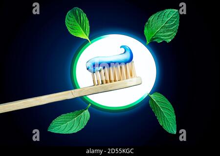 Bamboo toothbrush with fresh mint leaves and toothpaste Stock Photo