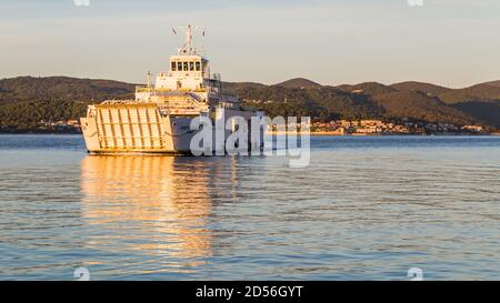 The car ferry from Korcula approaches Orebic early one morning in Croatia seen in October 2017. Stock Photo