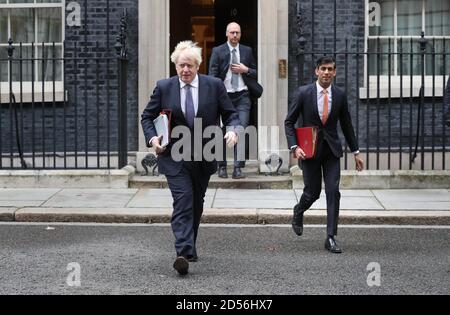 Prime Minister Boris Johnson (left) and Chancellor of the Exchequer Rishi Sunak (right) leave 10 Downing Street London, ahead of a Cabinet meeting at the Foreign and Commonwealth Office. Stock Photo