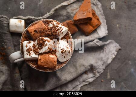 Hot chocolate and marshmallows. Hot Cocoa in a white cup. Dark background. Autumn drink concept. Copy space. Top view Stock Photo