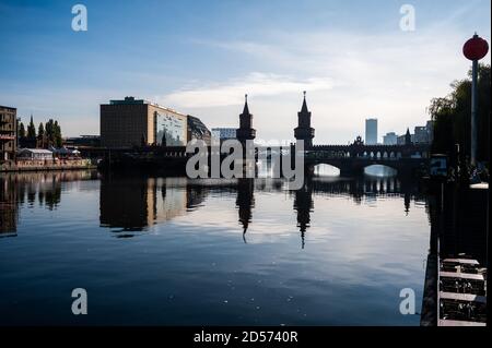 Berlin, Germany. 13th Oct, 2020. The Oberbaumbrücke between the Berlin districts of Kreuzberg and Friedrichshain is reflected in the water of the Spree. Credit: Christophe Gateau/dpa/Alamy Live News Stock Photo