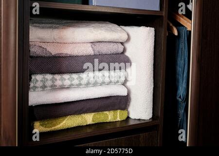 Terry towels are on the shelf in the closet. Stock Photo