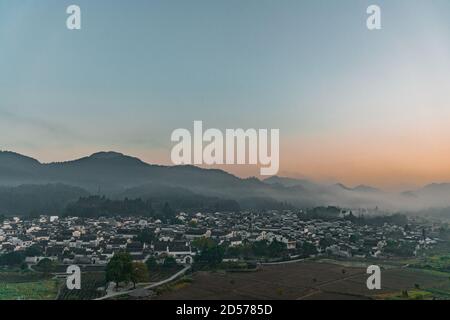 The panorama view of Xidi village, an ancient village in the mountains in Anhui, China, at sunrise. Stock Photo