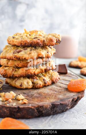 Oatmeal cookies. Homemade baking. Autumn concept of cookies with dried apricots and chocolate. Copy space. Light background. Stock Photo