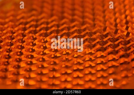 Macro shot of a bike reflector. Orange bike reflector. Stock Photo