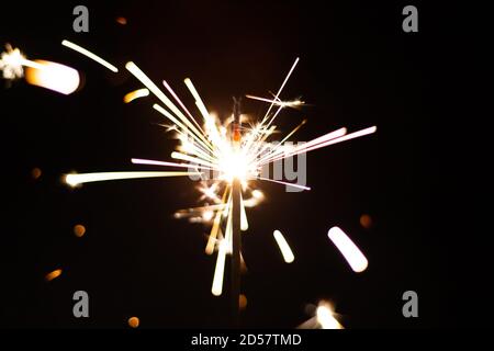 Glittering burning sparkler on black background background. New year or xmas concept Stock Photo