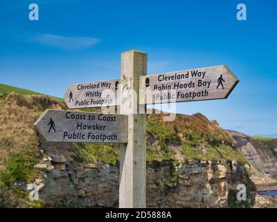 A wooden signpost near Robin Hood's Bay marks the junction of the Cleveland Way National Trail and the England Coast to Coast path Stock Photo