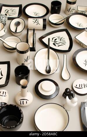 Creative composition made with Square, Circular, Oval and Triangle Shaped Crockery. Design made with Plates, Bowls and spoons. Grey Background. Indoor Stock Photo