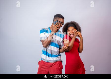 fun and exciting young african people making phone calls Stock Photo