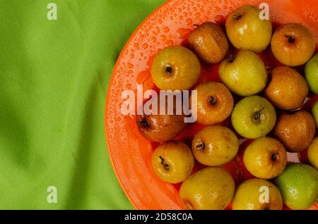 Fresh Bor, Ziziphus mauritiana or Chinese date or Indian plum. Placed on a Orange colored plate Stock Photo