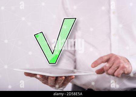 Validation concept above a tablet held by a man in background Stock Photo