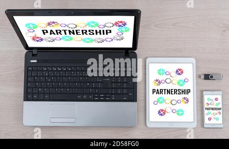 Partnership concept shown on different information technology devices Stock Photo