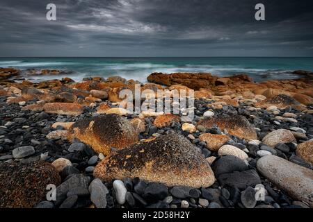 Colourful rocks at Friendly Beaches in Freycinet National Park. Stock Photo