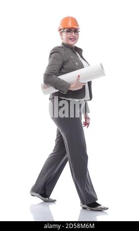 female architect with a roll of drawings striding towards you Stock Photo