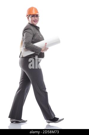 female architect with a roll of drawings striding towards you Stock Photo