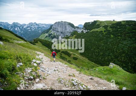Rear view of a woman hiking  in the Austrian Alps, Loser mountain region, Ausseerland, Austria Stock Photo