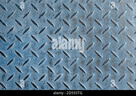 Abstract background of old blue rusty diamondplate rusty metal panel. Grunge brown rough grip industrial steel texture pattern Stock Photo