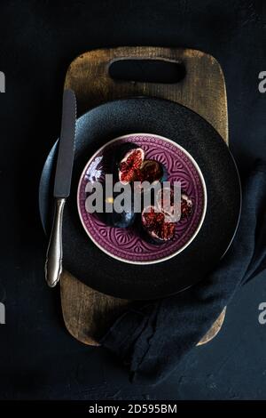 Overhead view of purple figs on a plate Stock Photo