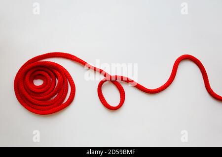 Red textured cord roll with curved line isolated on white background Stock Photo
