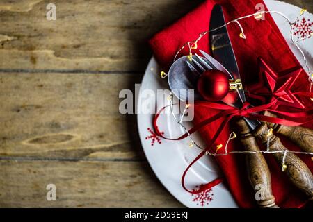 Overhead view of a Christmas place setting on a wooden table Stock Photo