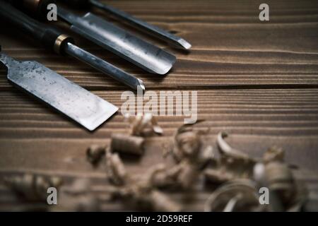 Close up view of a set of wood chisels for carving wood, sculpture tools on wooden background Stock Photo