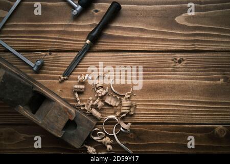 Top view of an old planer and other vintage carpenter tools in a carpentry workshop om a wooden table Stock Photo