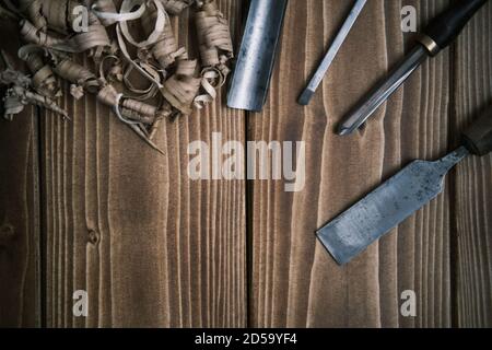Top view layout of a set of wood chisels for carving wood, sculpture tools on wooden background Stock Photo
