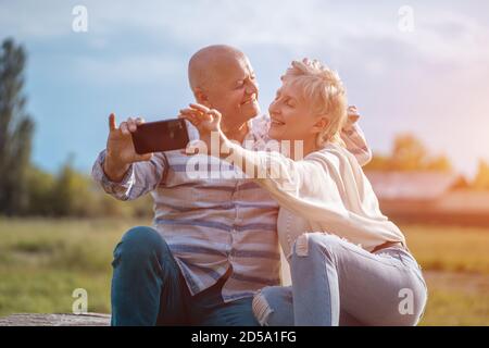happy senior couple dating, taking selfie and have fun outdoor Stock Photo