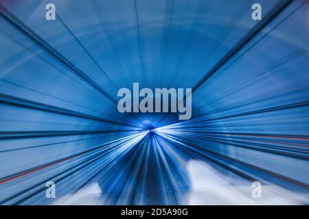 Motion blur of train moving inside tunnel Stock Photo