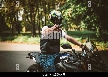BELGR, SERBIA - Sep 13, 2020: Assassin on the motorcycle is holding gun, the crime scene Stock Photo