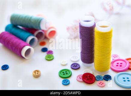 Color threads and sewing accessories on white background Stock Photo