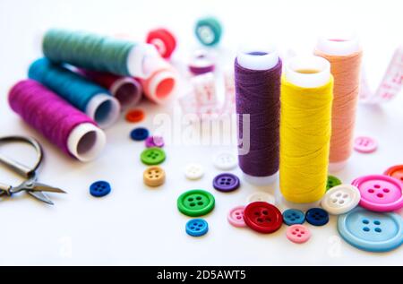 Color threads and sewing accessories on white background Stock Photo