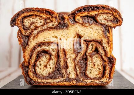 Cocoa and nuts sweet bread on black plate, front view Stock Photo