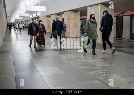 Moscow. Russia. October 5, 2020 People passengers with face masks inside a metro station. Preventive protection measures during the next wave of the Stock Photo