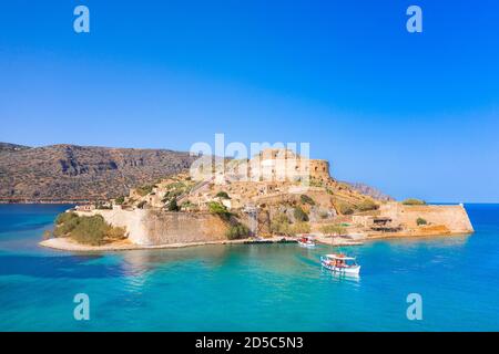 View of the island of Spinalonga with calm sea. Here were isolated lepers, humans with the Hansen's desease, gulf of Elounda, Crete, Greece. Stock Photo