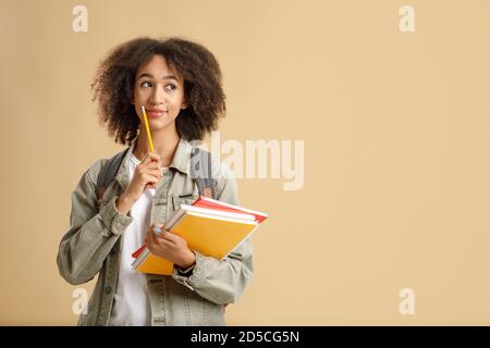 Cute friendly african american woman with smart watch holding notepad Stock Photo